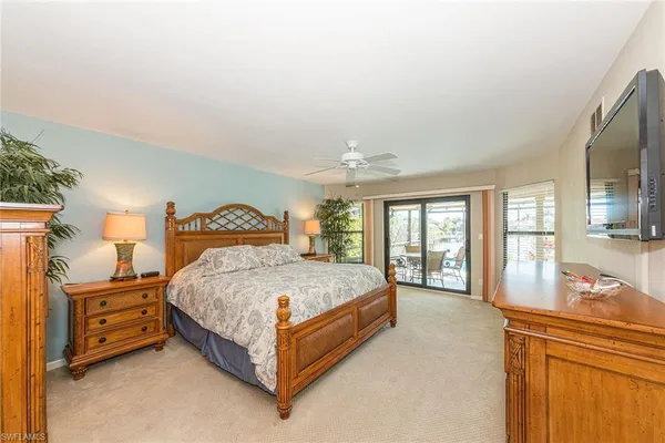 a spacious bedroom with a bed and large windows