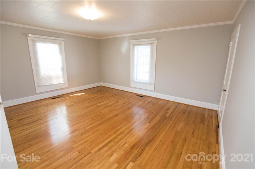 200 Hiddenite Church Road Hiddenite, NC 28636 - Photo 13 of 20 an empty room with wooden floor and windows