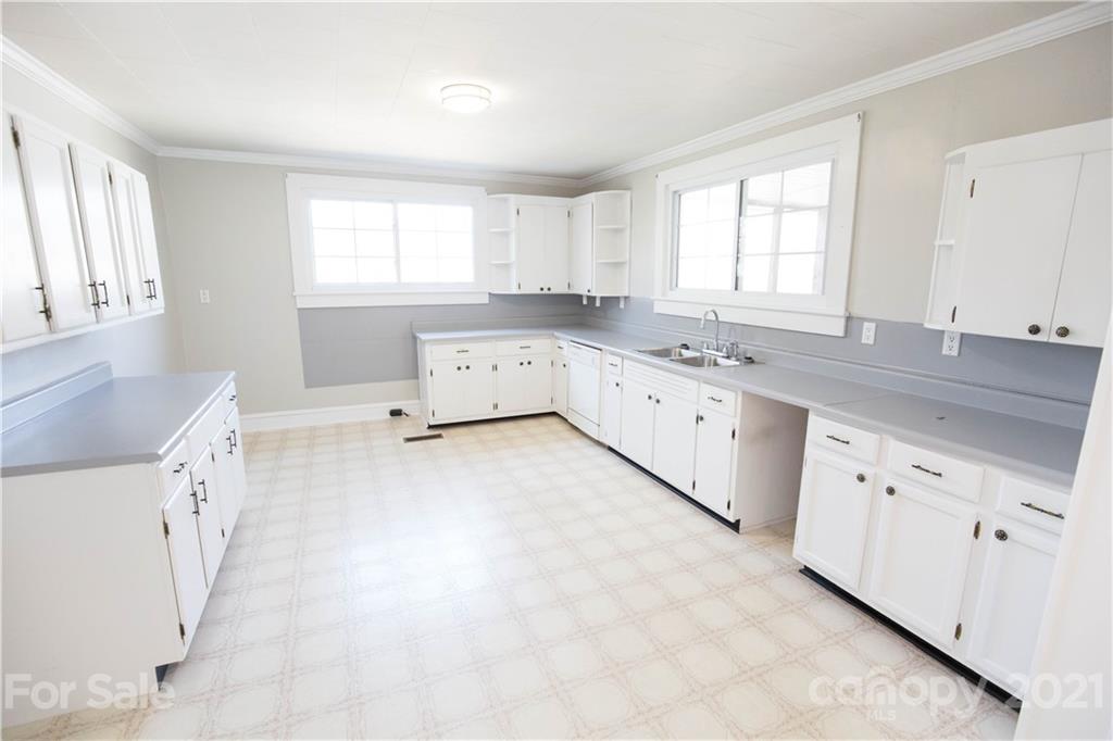 200 Hiddenite Church Road Hiddenite, NC 28636 - Photo 15 of 20 a kitchen with granite countertop a sink white cabinets and window