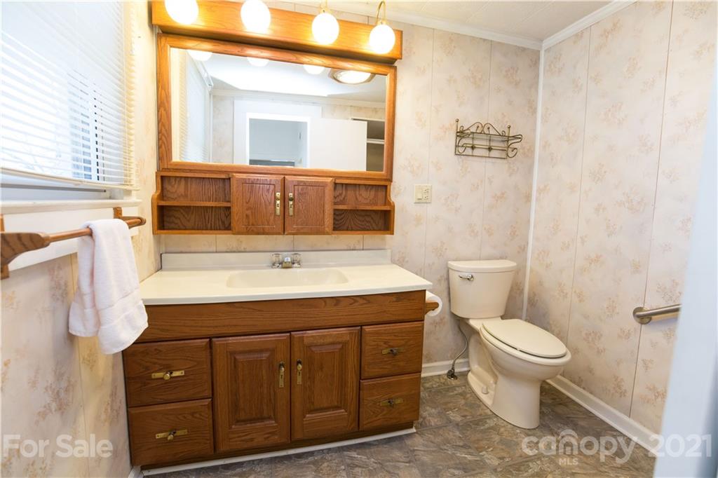 200 Hiddenite Church Road Hiddenite, NC 28636 - Photo 17 of 20 a bathroom with a sink a toilet and a mirror