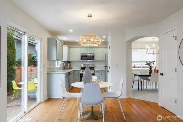 a kitchen with granite countertop a sink stainless steel appliances and cabinets
