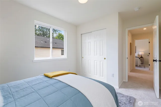 a bedroom with a bed and window