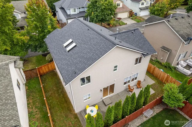 an aerial view of a house with a mountain