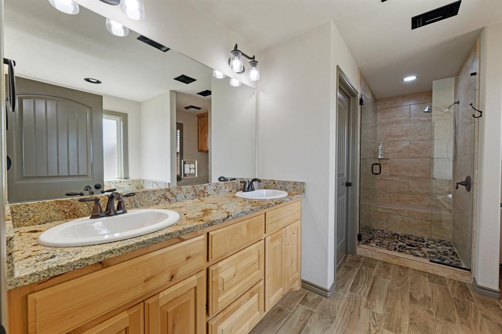 2387 County Road 407 Nemo, TX 76070 - Photo 14 of 30 a bathroom with a shower sink vanity granite and mirror