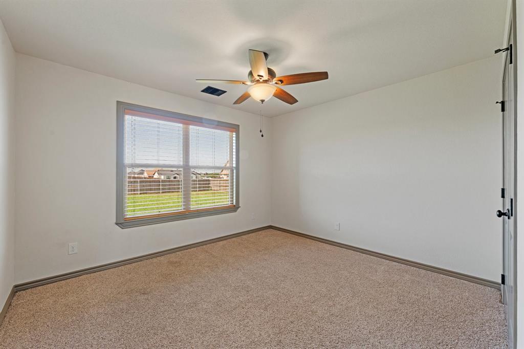 2387 County Road 407 Nemo, TX 76070 - Photo 22 of 30 an empty room with windows and fan