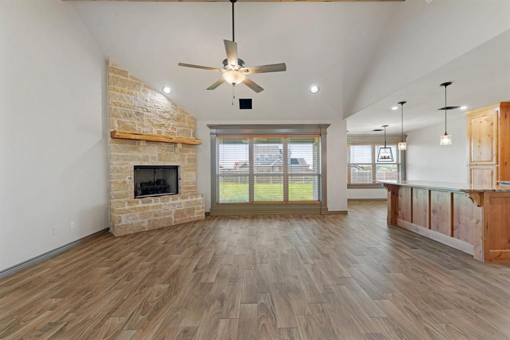 2387 County Road 407 Nemo, TX 76070 - Photo 4 of 30 a view of an empty room with wooden floor and a fireplace