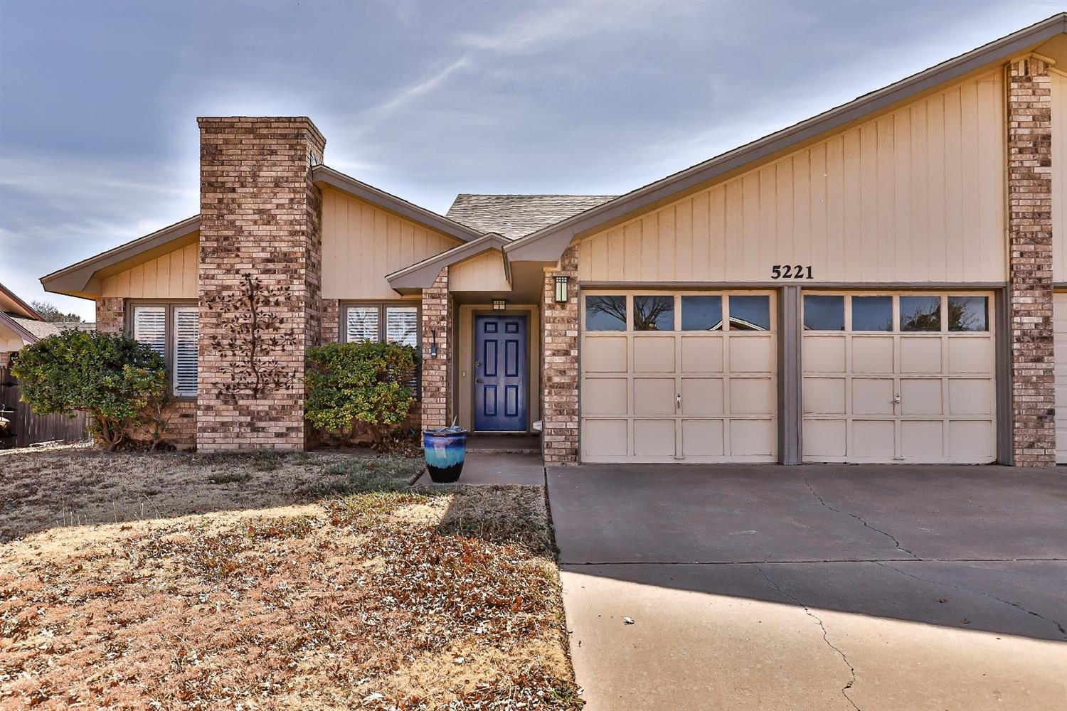 5221 84th Street Lubbock, TX 79424 - Photo 1 of 42 a front view of a house with garden