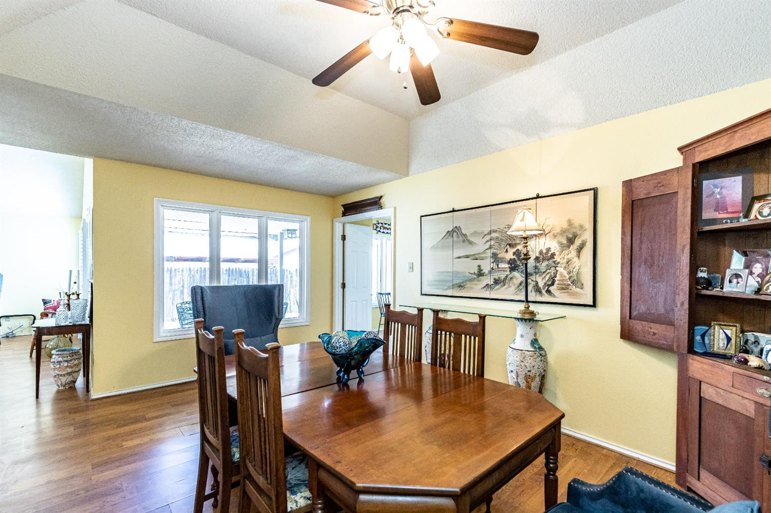 5221 84th Street Lubbock, TX 79424 - Photo 12 of 42 a view of a dining room with furniture and wooden floor
