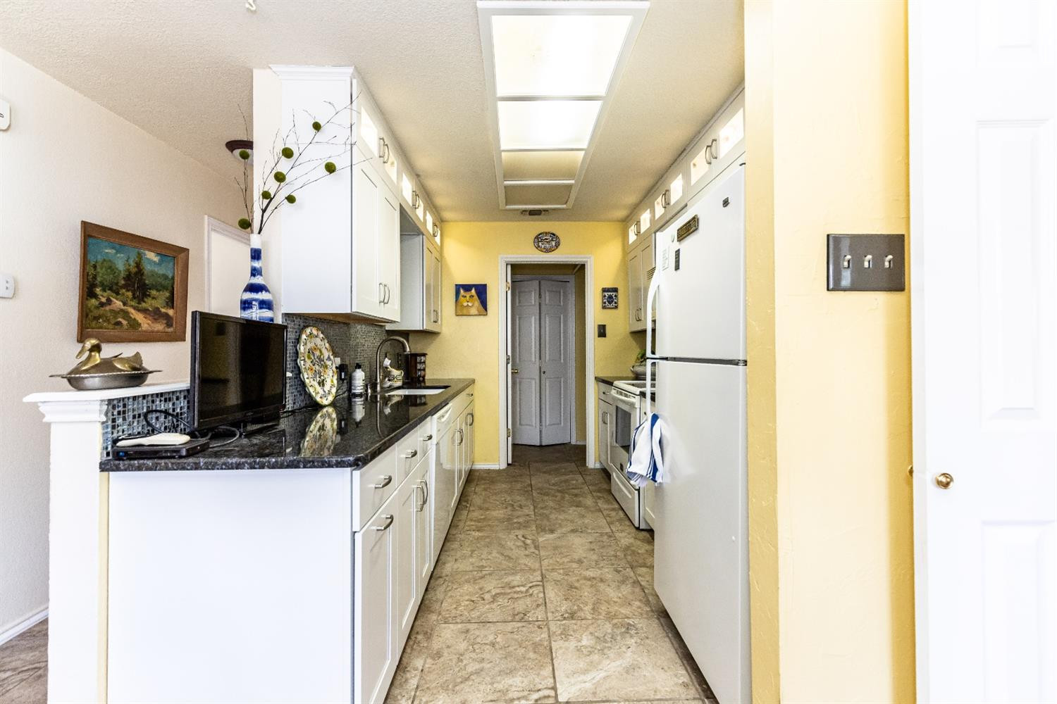 5221 84th Street Lubbock, TX 79424 - Photo 13 of 42 a kitchen with a sink and a refrigerator