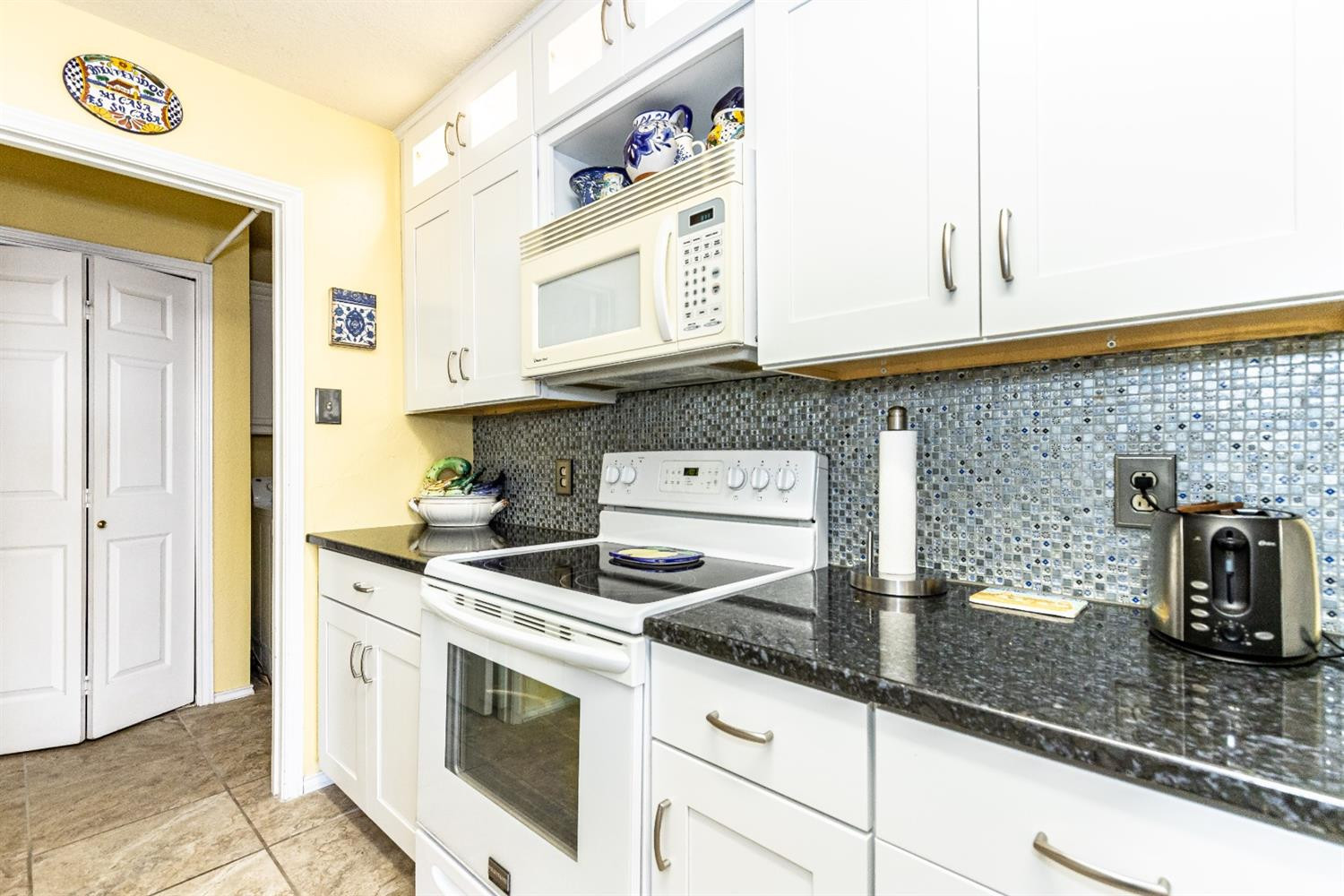5221 84th Street Lubbock, TX 79424 - Photo 15 of 42 a kitchen with stainless steel appliances granite countertop a sink and a stove