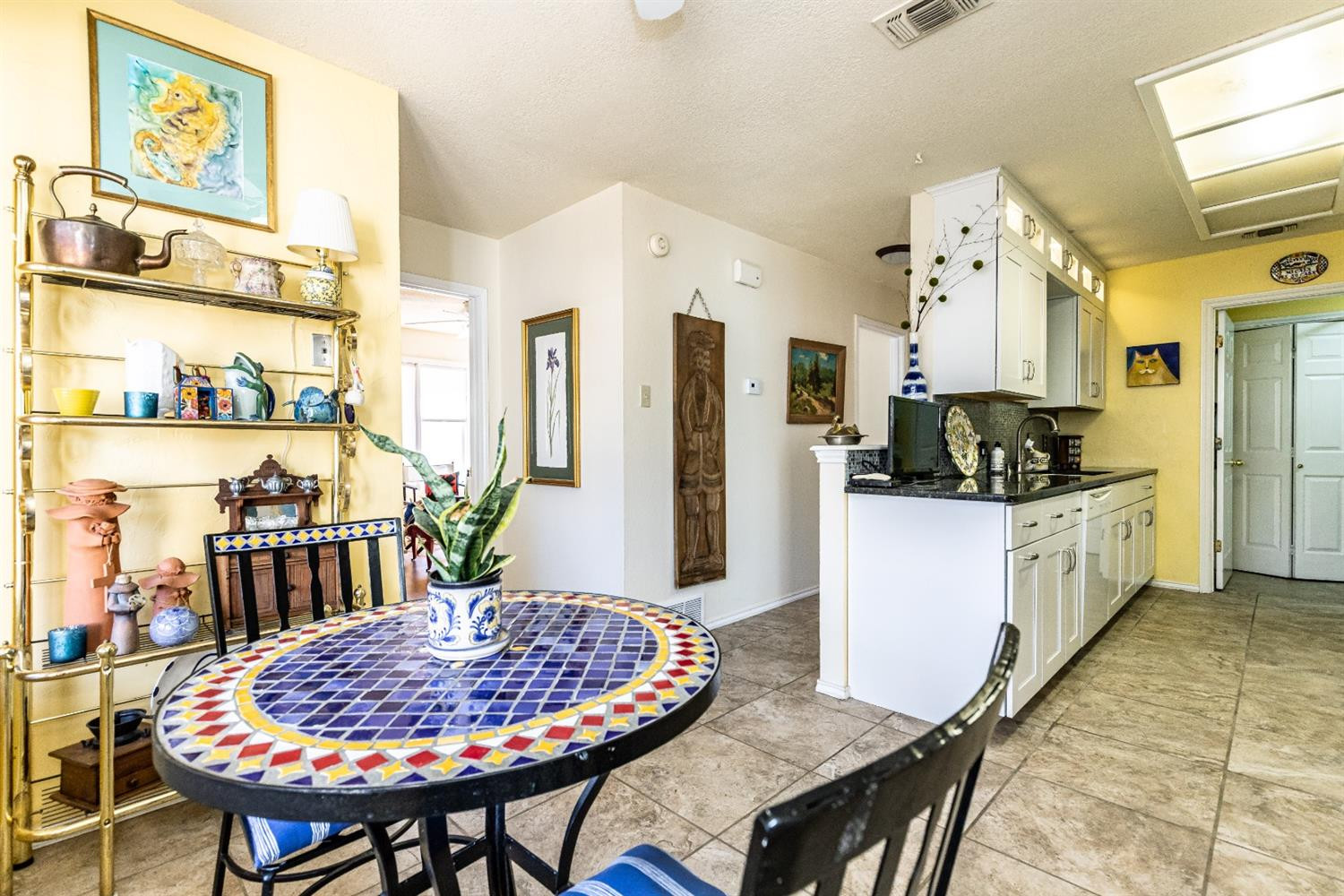 5221 84th Street Lubbock, TX 79424 - Photo 20 of 42 a kitchen with stainless steel appliances granite countertop a dining table chairs and a refrigerator