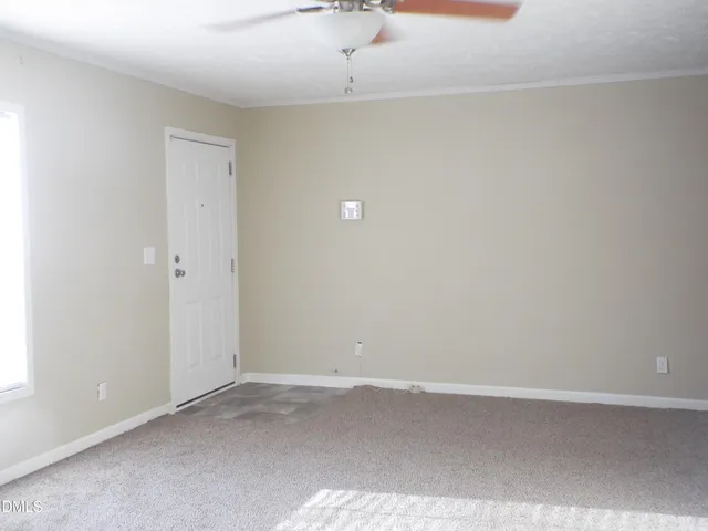 a view of empty room with fireplace