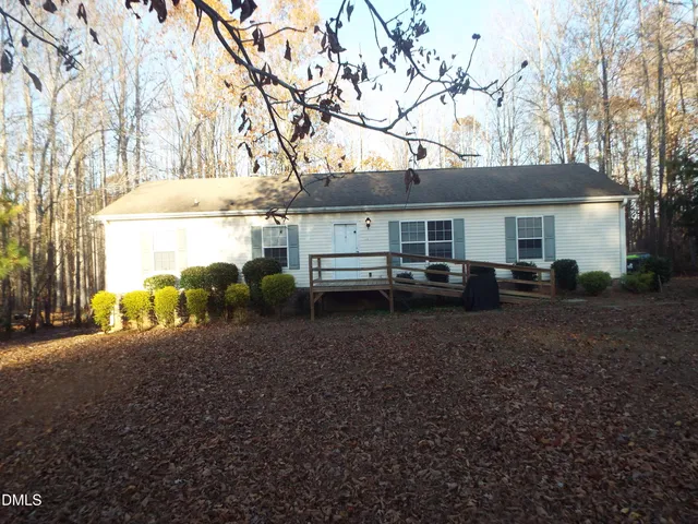 a view of a house with a tree in the background