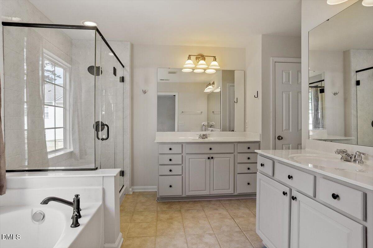 2746 Laurel Cherry Street Raleigh, NC 27612 - Photo 18 of 23 a spacious bathroom with a double vanity sink mirror and double