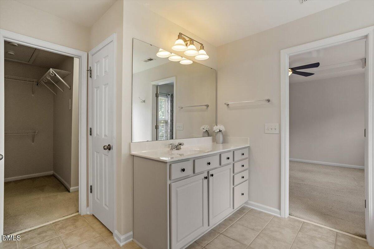 2746 Laurel Cherry Street Raleigh, NC 27612 - Photo 19 of 23 a bathroom with a granite countertop sink a mirror and a shower