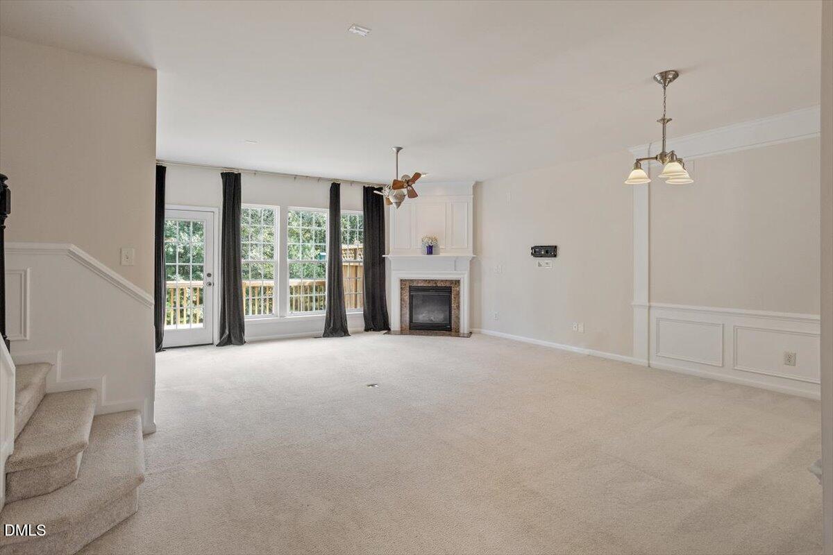 2746 Laurel Cherry Street Raleigh, NC 27612 - Photo 4 of 23 a view of an empty room with a fireplace and a window