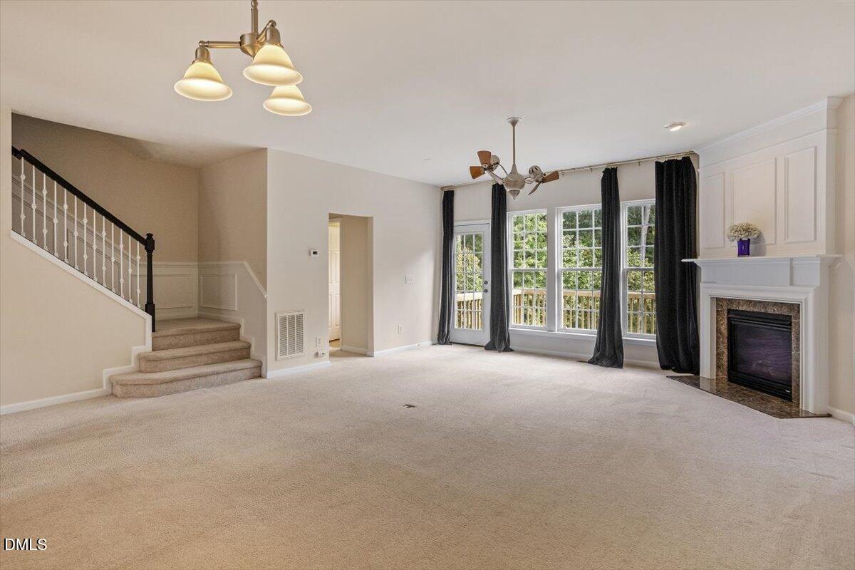 2746 Laurel Cherry Street Raleigh, NC 27612 - Photo 7 of 23 a view of an empty room with a fireplace and a window