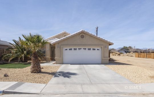 1411 Sims Street Ridgecrest, CA 93555 - Photo 2 of 35 a front view of a house with a yard