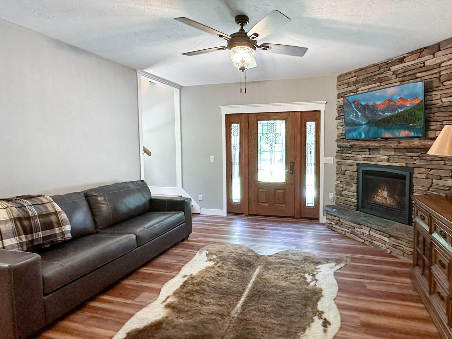 16878 Pasquale Road Nevada City, CA 95959 - Photo 15 of 36 a living room with furniture a flat screen tv and a fireplace