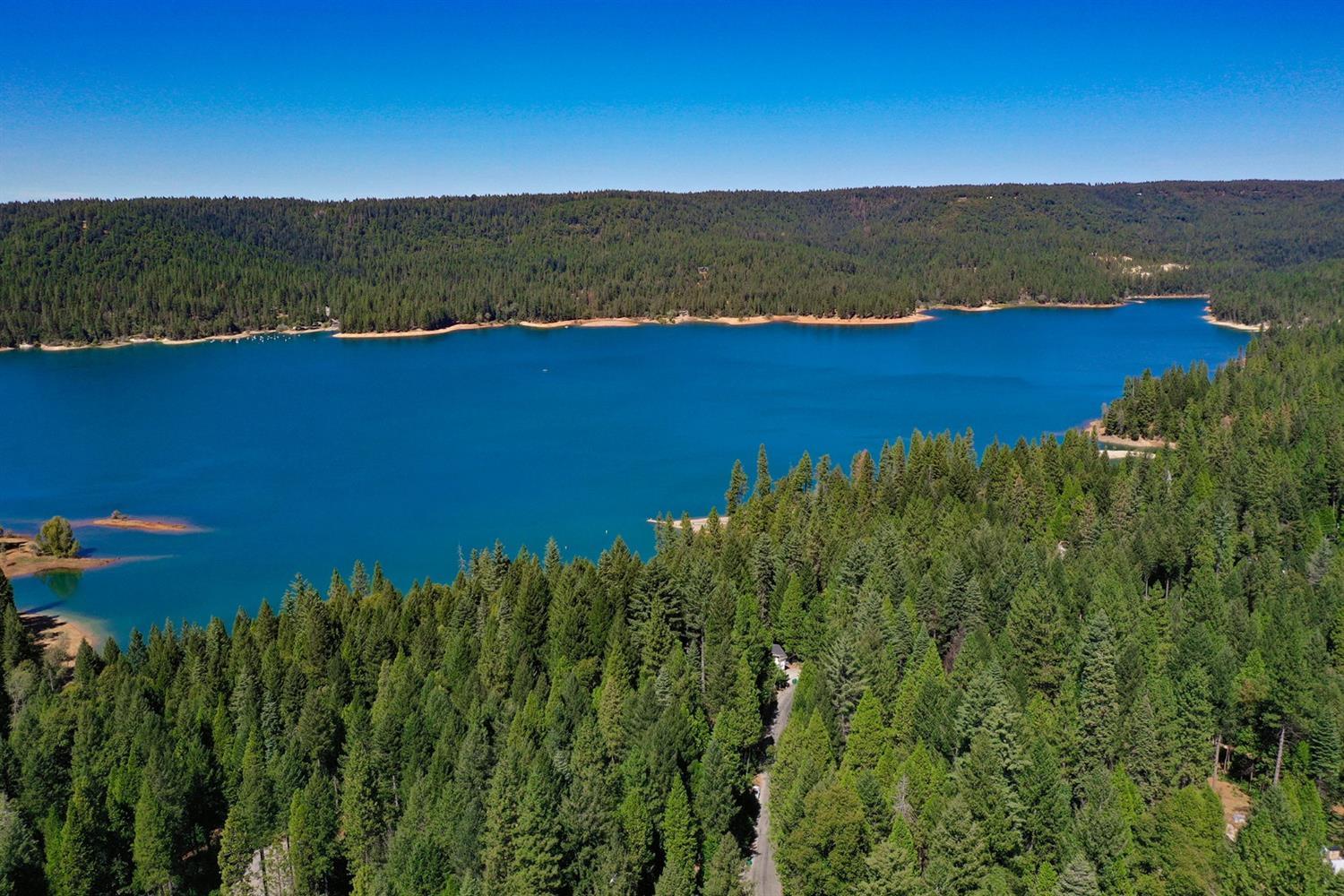 16878 Pasquale Road Nevada City, CA 95959 - Photo 18 of 36 a view of a lake in middle of a field with a mountain in the background