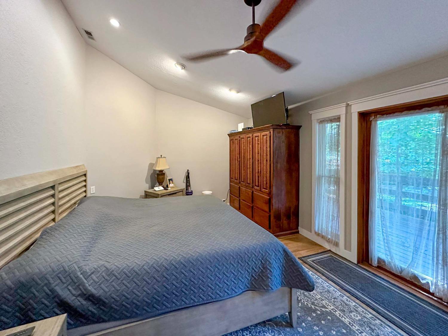 16878 Pasquale Road Nevada City, CA 95959 - Photo 10 of 36 a bedroom with a bed and a chandelier