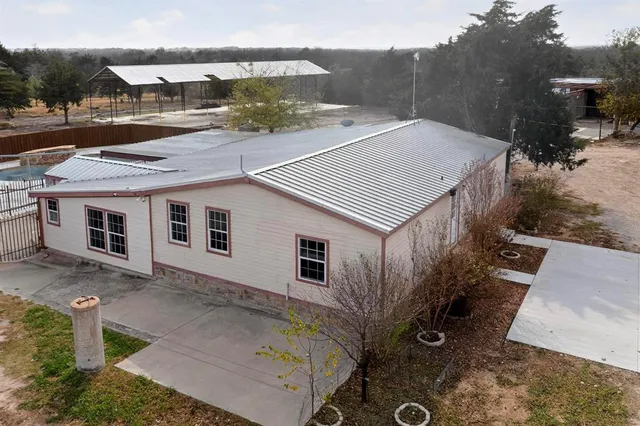 a aerial view of a house with a yard