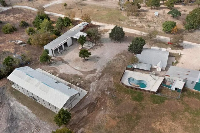 an aerial view of a house with outdoor space