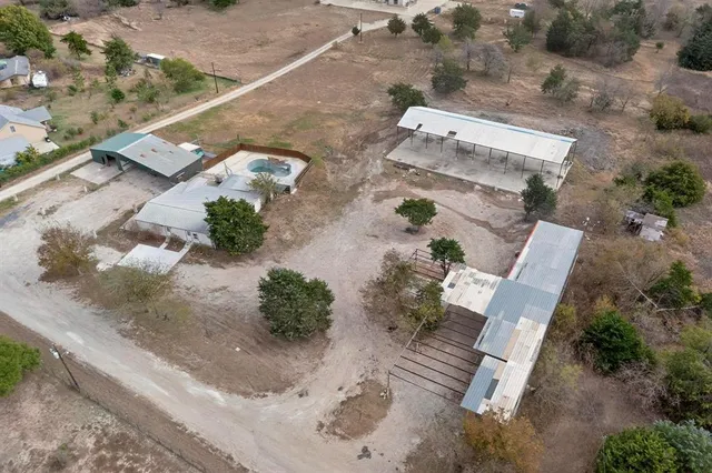 an aerial view of a house with a yard and garden