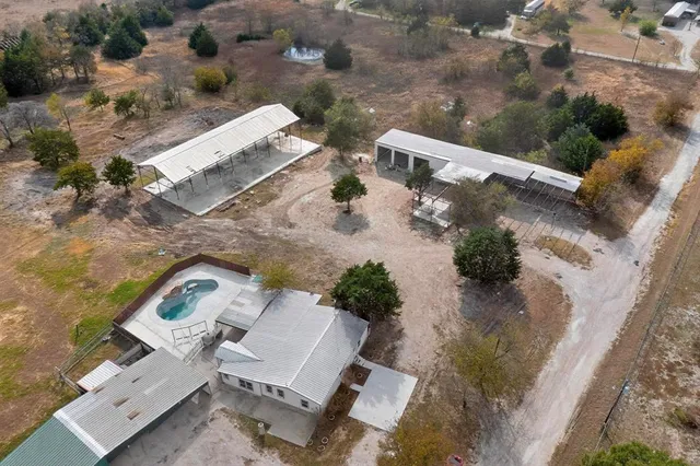 an aerial view of a house with a yard