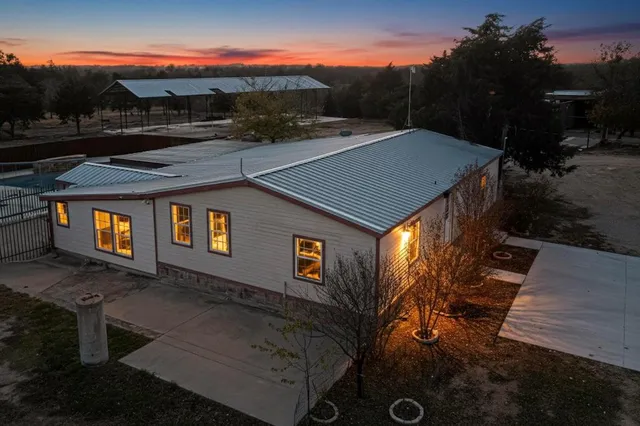 a view of a street with potted plants