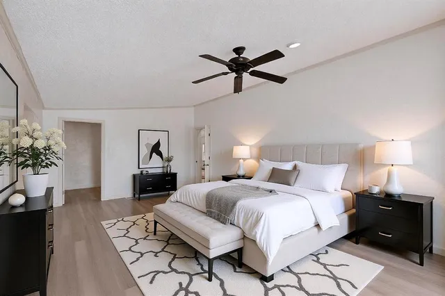 a bedroom with a bed and a chandelier