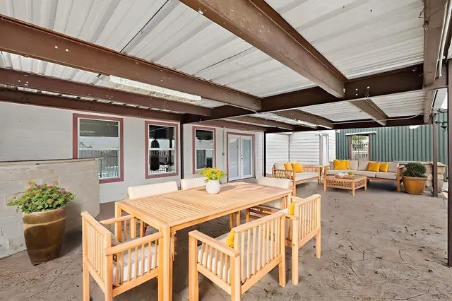 a view of a patio with table and chairs potted plants