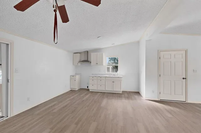 a room with a wooden floor and white walls