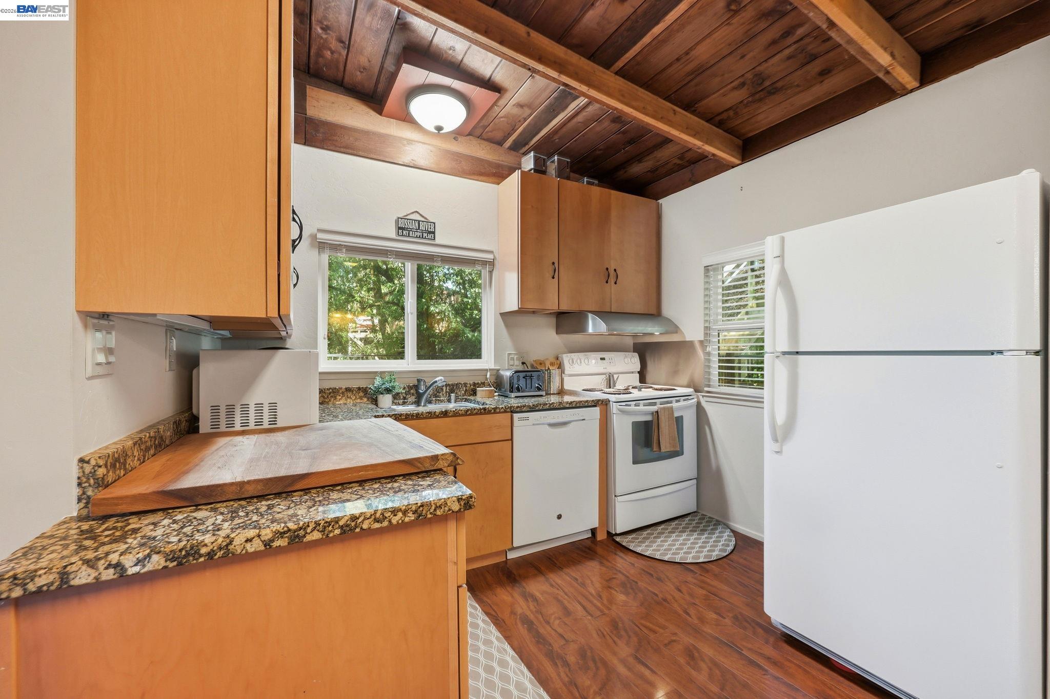 11700 Oak Road Forestville, CA 95436 - Photo 5 of 20 a kitchen with a refrigerator a stove a sink dishwasher and wooden cabinets with wooden floor