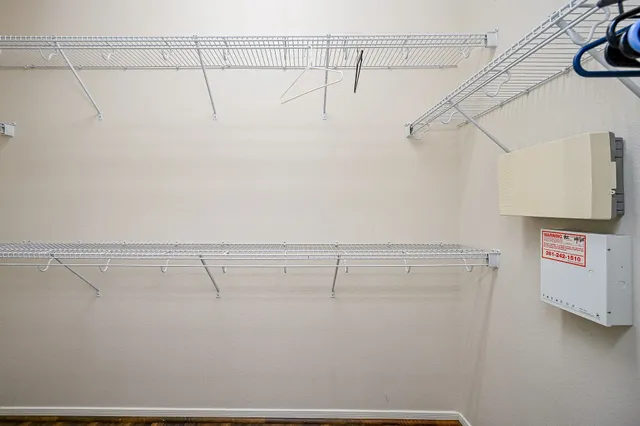 a view of storage and utility room with racks on the wall