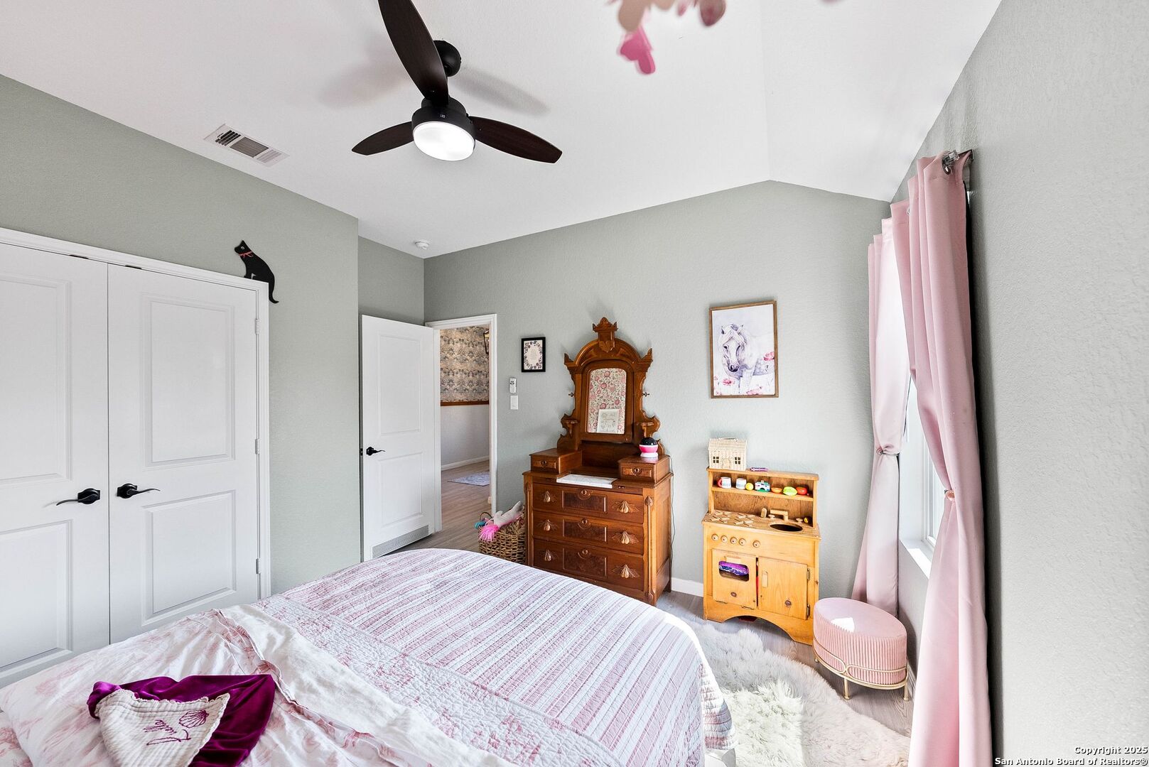 5483 Jasmine Bulverde, TX 78163 - Photo 20 of 71 a bedroom with a bed and a chandelier