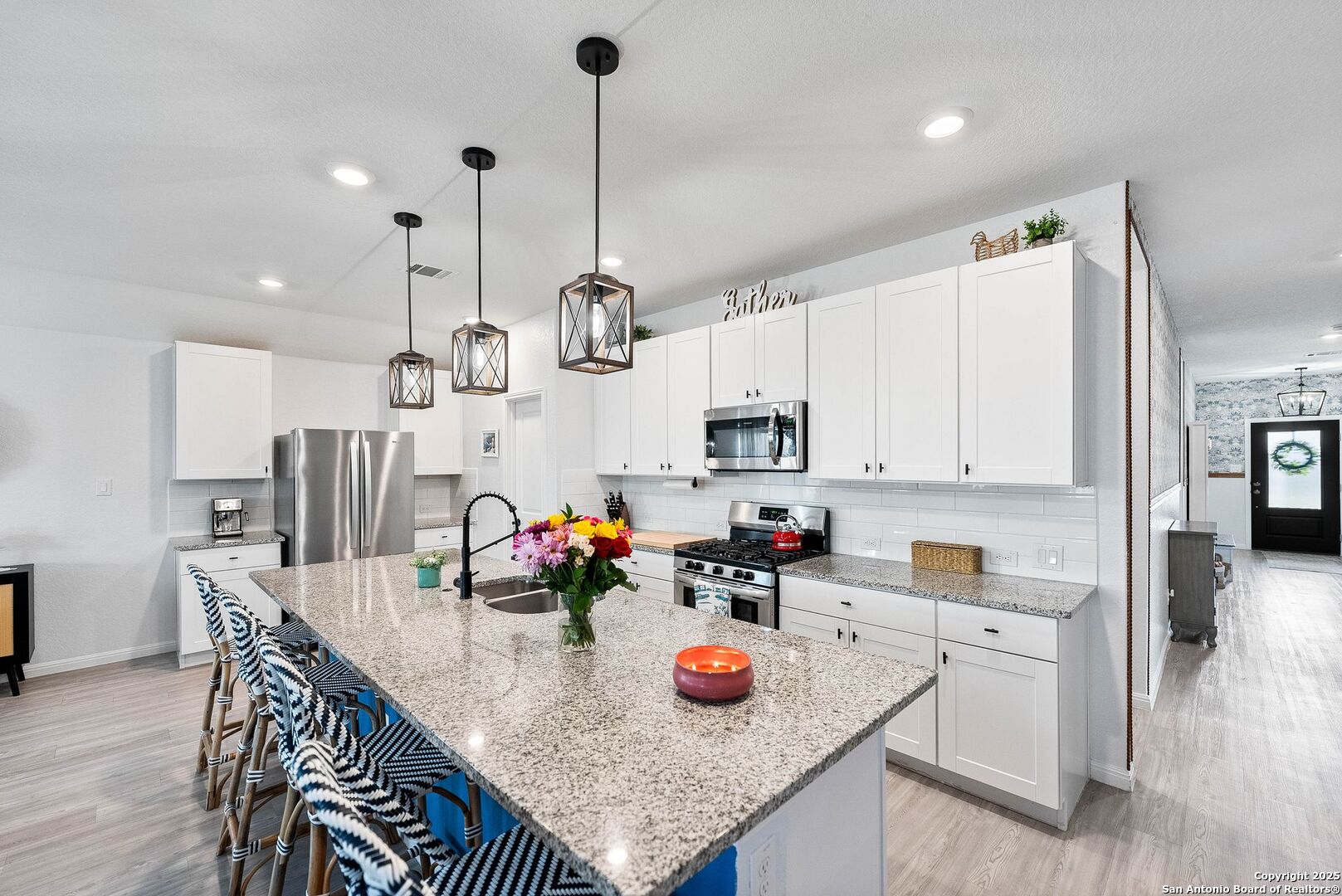 5483 Jasmine Bulverde, TX 78163 - Photo 6 of 71 a kitchen with stainless steel appliances granite countertop a sink a stove and chairs