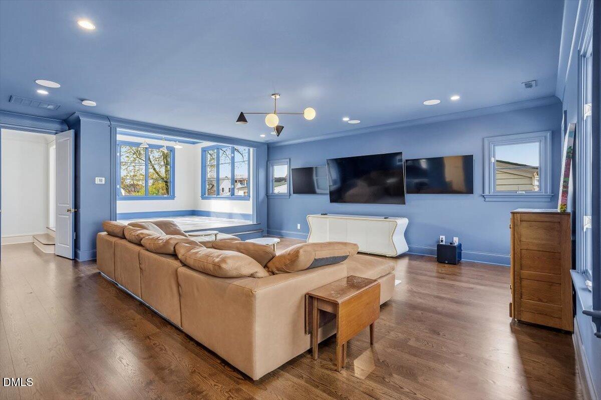 2123 St Marys Street Raleigh, NC 27608 - Photo 40 of 77 a living room with furniture and a flat screen tv