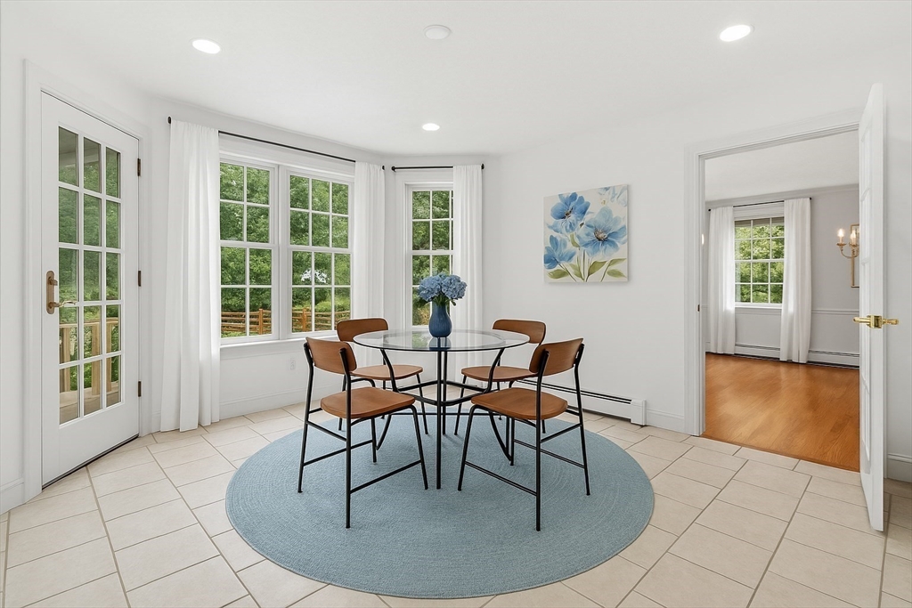 276 High Street Winchester, MA 01890 - Photo 11 of 38 a dining room with chandelier and wooden floor