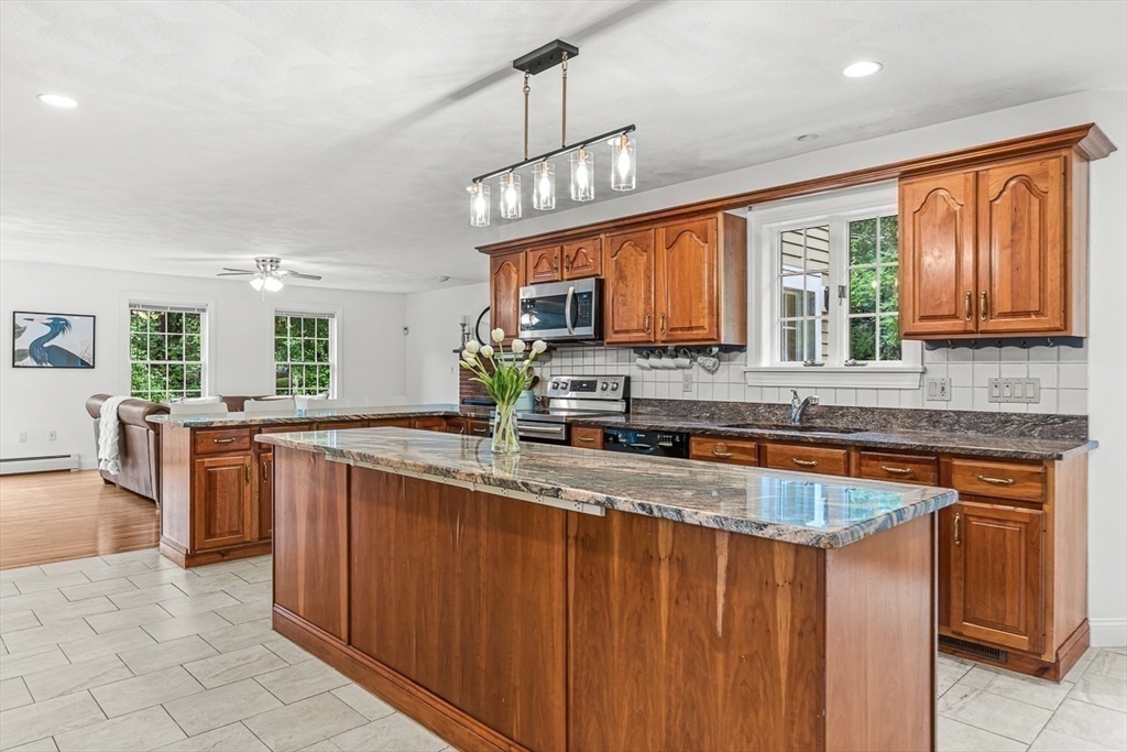 276 High Street Winchester, MA 01890 - Photo 14 of 38 a kitchen with stainless steel appliances granite countertop wooden cabinets a sink and dishwasher
