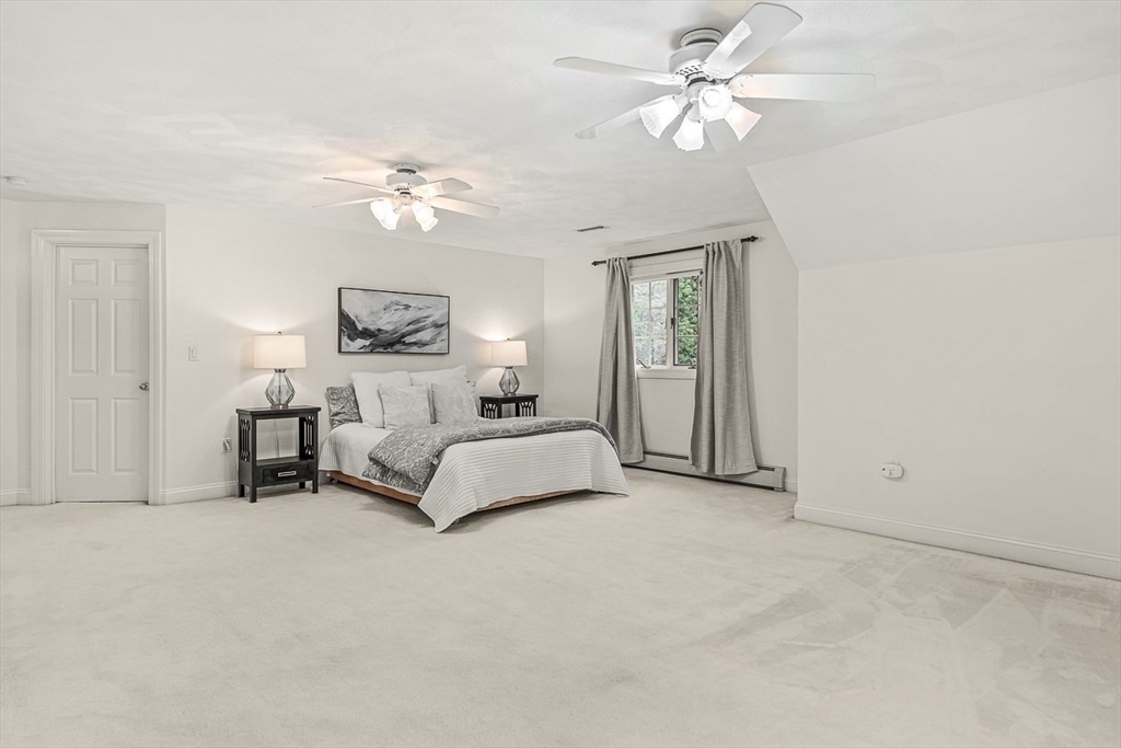 276 High Street Winchester, MA 01890 - Photo 25 of 38 a spacious bedroom with a bed and a ceiling fan