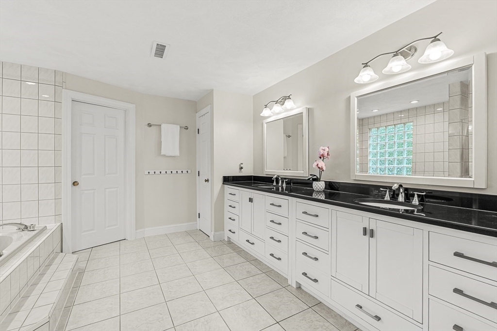276 High Street Winchester, MA 01890 - Photo 26 of 38 a spacious bathroom with a granite countertop sink a mirror and a bathtub