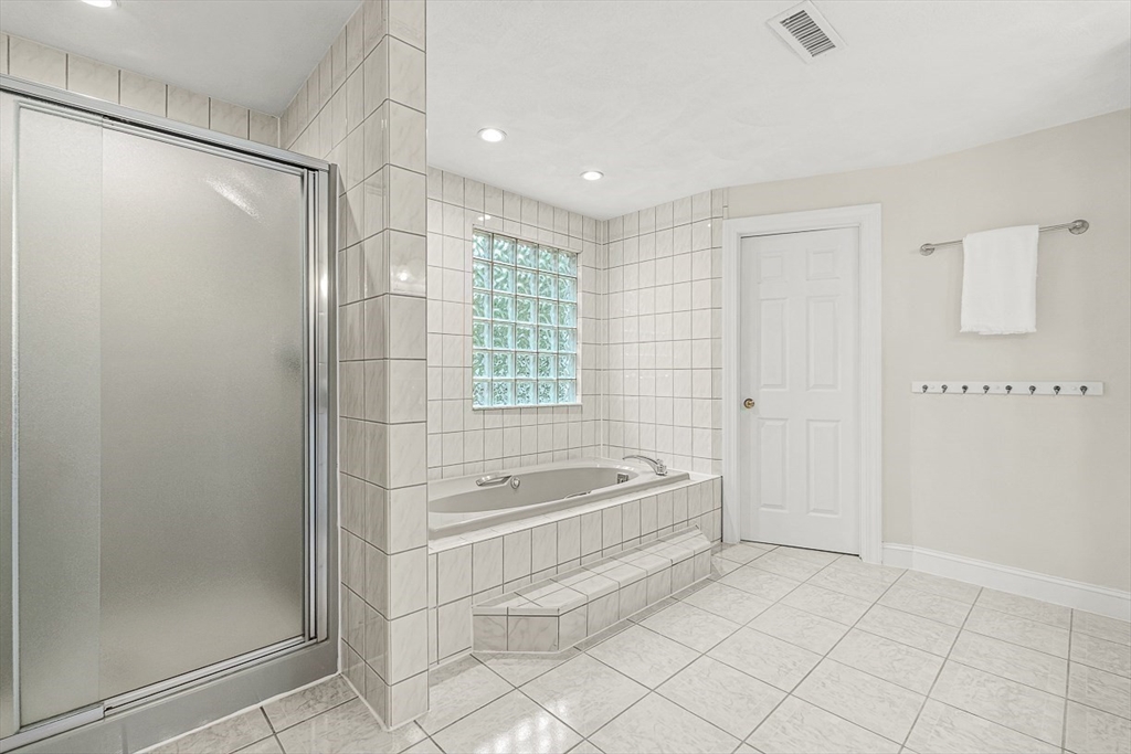 276 High Street Winchester, MA 01890 - Photo 27 of 38 a spacious bathroom with a bathtub and a shower
