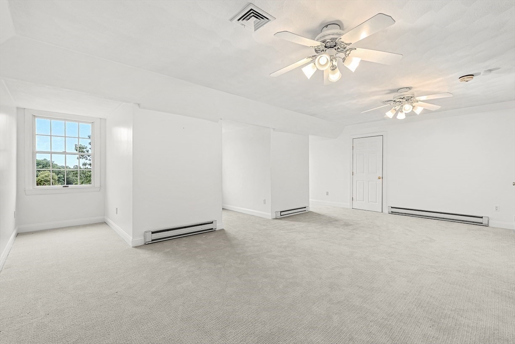 276 High Street Winchester, MA 01890 - Photo 32 of 38 an empty room with windows and fan