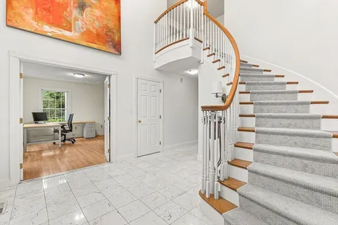 a view of staircase with white walls and railing