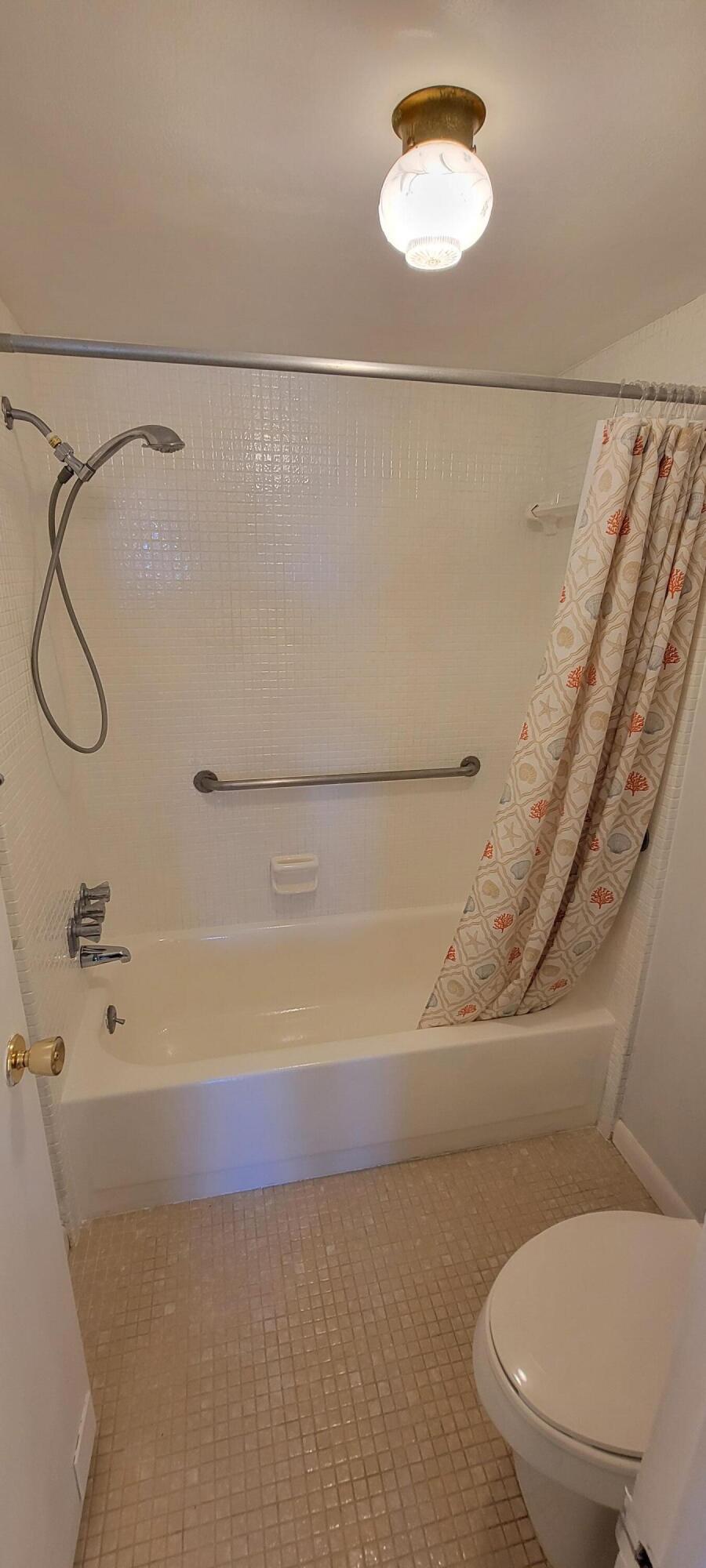 410 Wilma Circle, Unit 308 Riviera Beach, FL 33404 - Photo 11 of 27 a bathroom with a toilet and a shower
