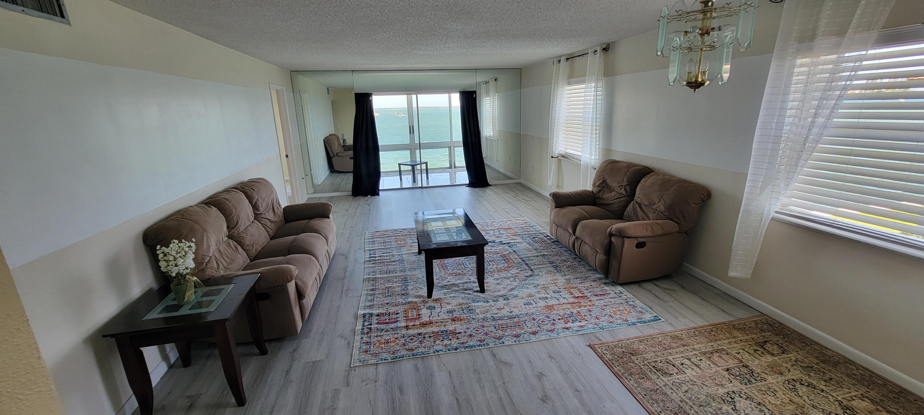 410 Wilma Circle, Unit 308 Riviera Beach, FL 33404 - Photo 22 of 27 a living room with furniture and a window