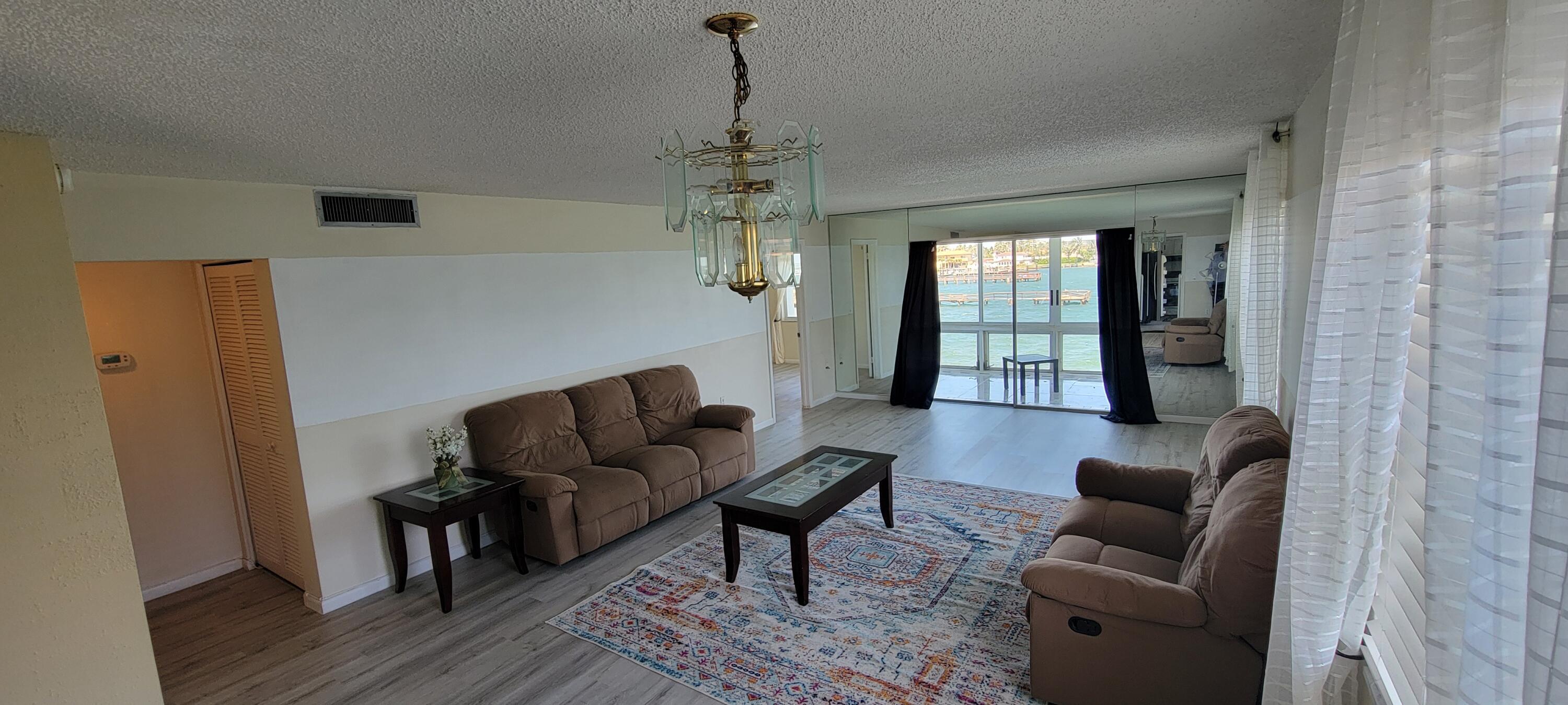 410 Wilma Circle, Unit 308 Riviera Beach, FL 33404 - Photo 23 of 27 a living room with furniture and a window
