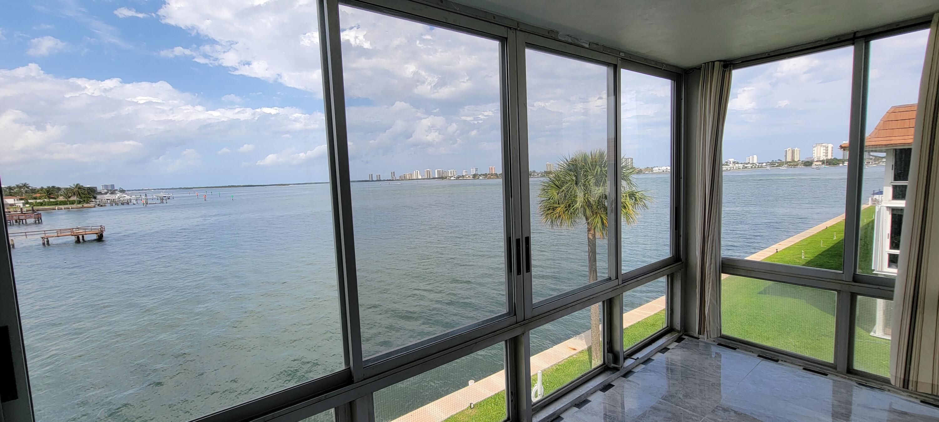 410 Wilma Circle, Unit 308 Riviera Beach, FL 33404 - Photo 4 of 27 a view of a balcony with floor to ceiling windows with wooden floor