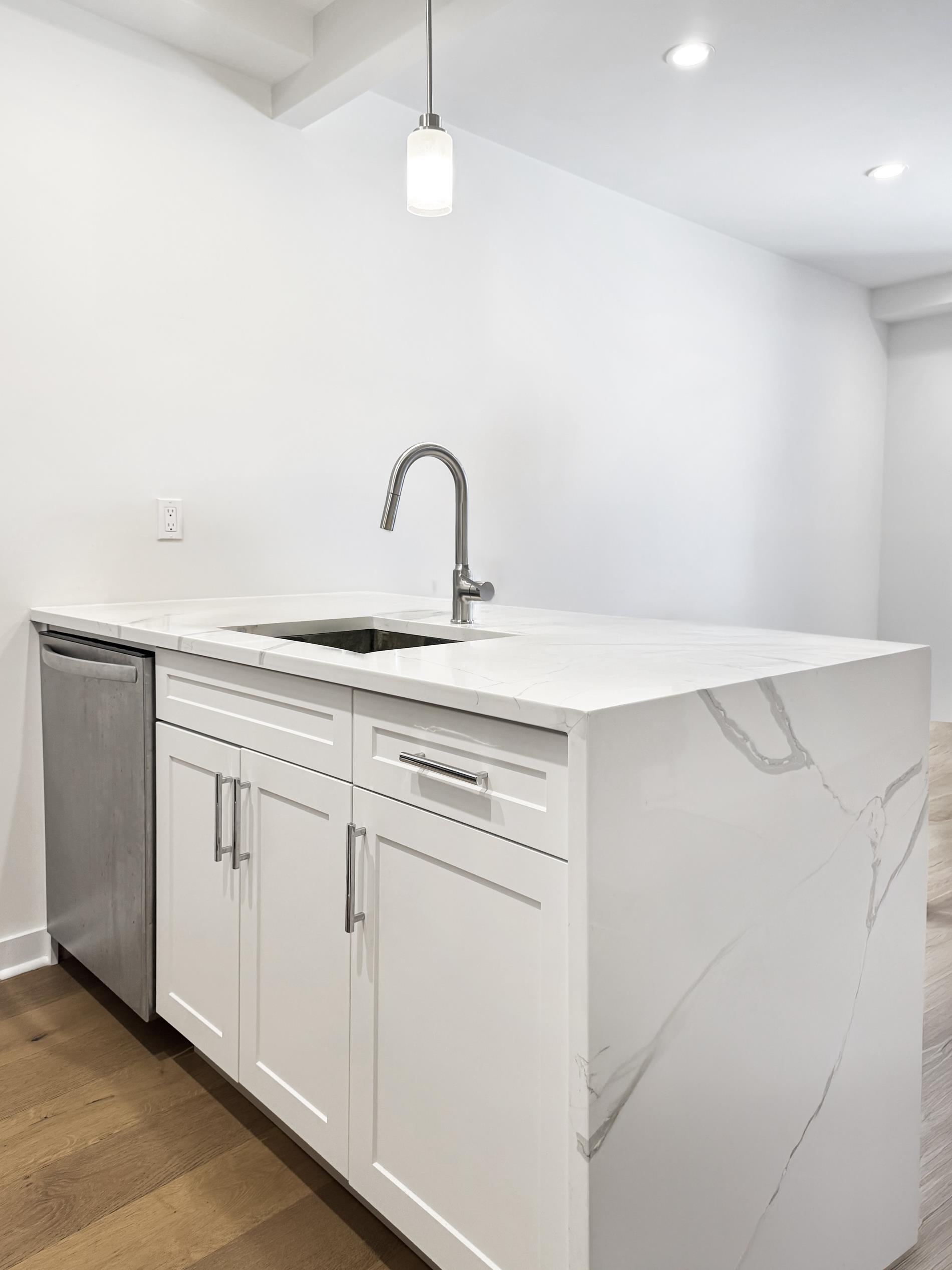 31-22 29th Street, Unit 2B Queens, NY 11106 - Photo 6 of 11 a view of a kitchen with white cabinets